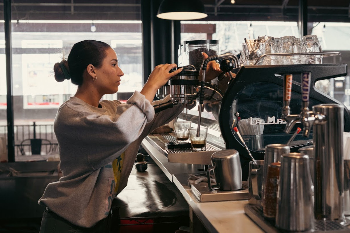 Staff pouring coffee at a coffee bar